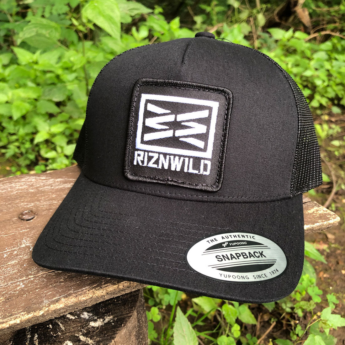 black trucker hat, RIZNWILD snapback, curved bill mesh hat, embroidered logo hat, outdoor lifestyle cap, everyday trucker hat, men’s black hat, streetwear cap